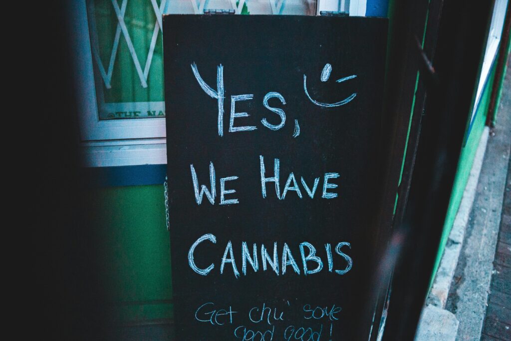 Board with cannabis offer near wall of building